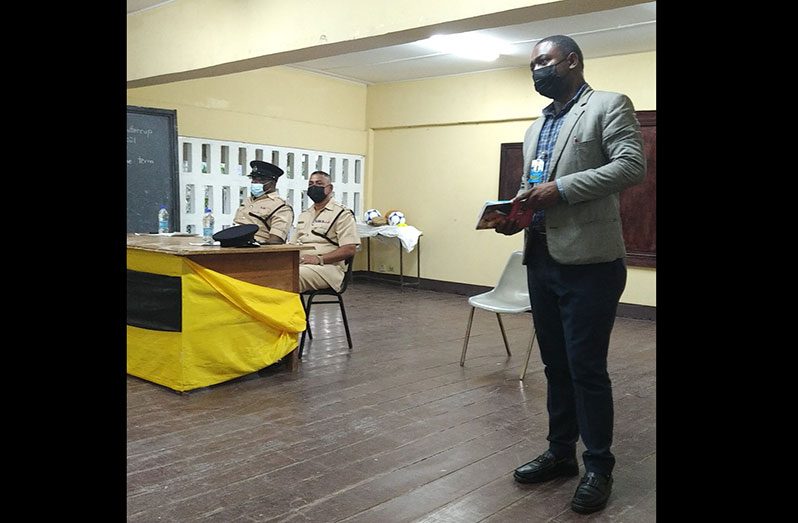 PYARG’s Chief Executive Officer (CEO), Ivan Bentham (standing), delivering his remarks.  Also pictured sitting at the head table are Regional Commander, Senior Superintendent Khalil Pareshram (centre), and Assistant Superintendent Jermaine Dufu