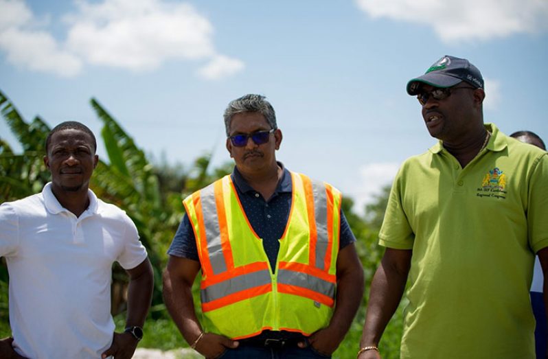 Minister of Public Infrastructure, David Patterson (right) with Bagotsville’s Nigel Garraway (left),  and GAICO Construction’s  Komal Singh