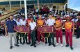 The members of the team pose with the students and their bags