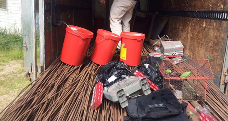Personal items belonging to the Chinese watchman stationed at Coomacka, Region 10. Cage with parrots and laptop are visible in the photo