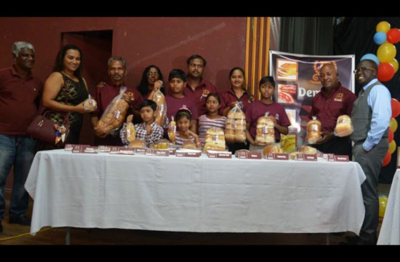 Demerara Bakery General Manager, Kenneth Scrubb with family and employees showcasing the delicious bread and pastries produced by the company