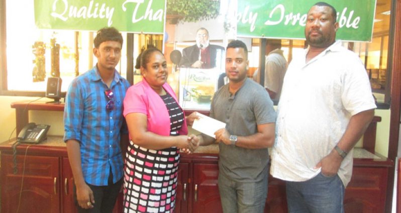 Bakewell Administrative Assistant Ms. Natasha Bhikhari hands over sponsorship to RHTYSC Club Captain Shawn Perriera