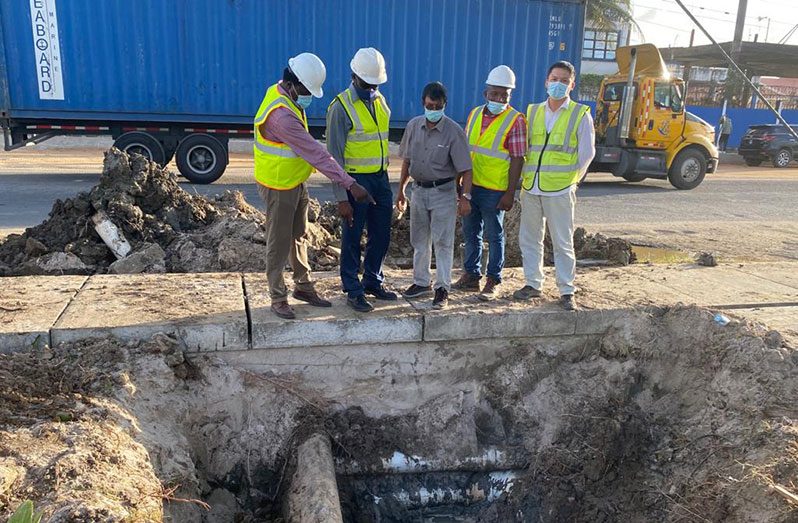 GWI's CEO, Shaik Baksh (centre) on site at Mandela Avenue, where old pipelines are to be decommissioned