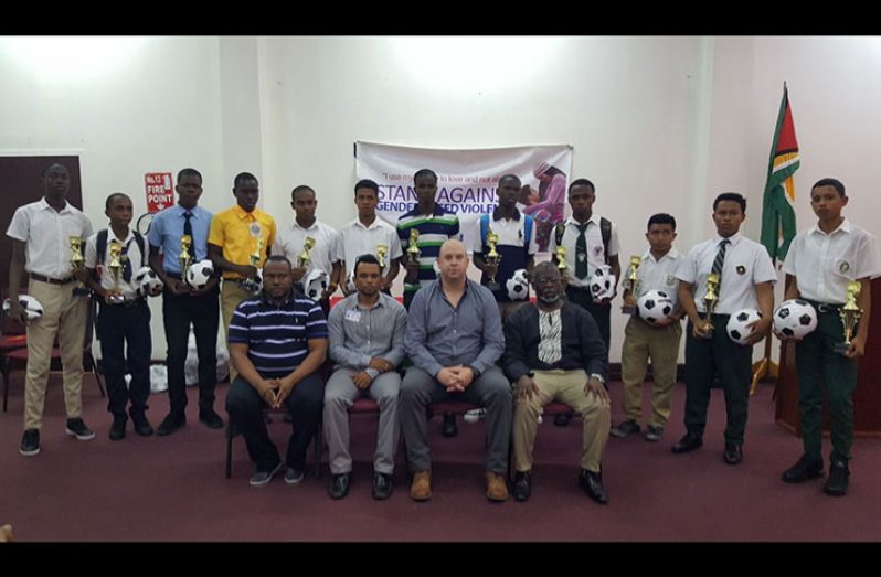 The students of the schools participating in the sixth edition of the Milo U-18 football tournament stand with Ministry of Public Health officials and organisers. (Stephan Sookram photo)