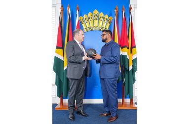 FIFA VP and CONCACAF President, Victor Montagliani, presents a ball to Guyana’s Head of State, President Dr. Irfaan Ali