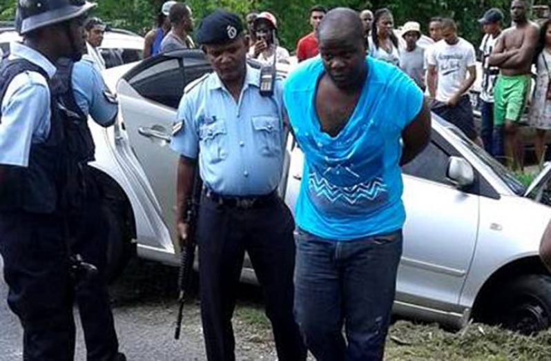 One of the suspected bandits being arrested by lawmen at the scene (Timothy Bhagwandin photo)