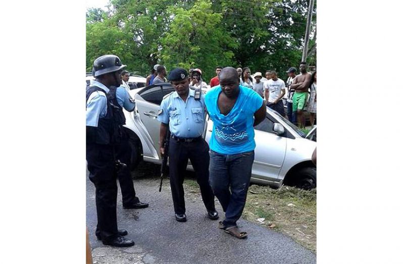 One of the suspected bandits being arrested by the lawmen at the scene. (Timothy Bhagwandin photo)