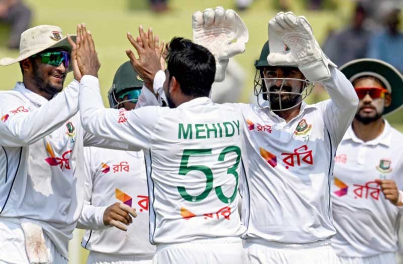 The Bangladesh players celebrate their maiden Test win over Pakistan