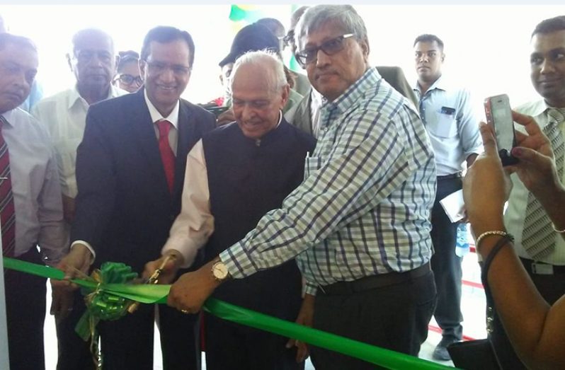 The ceremonial cutting of the ribbon officially opening the new branch, in picture are the Bank’s CEO, Pravinchandra Dave, the bank’s founder and Chairman Dr. Yesu Persaud and Director and Chairman DDL Komal Samaroo