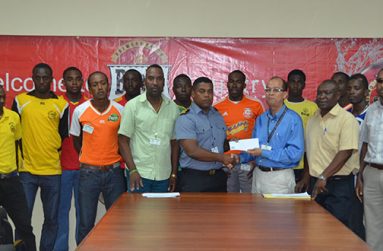 Banks Beer Brand Manager Brian Choo-Hen hands over the sponsor’s cheque to GFA President Vernon Burnett at yesterday’s launch of the 4th Annual GFA Banks Beer Cup.