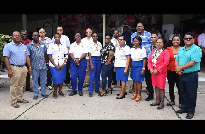 Mr. Clifford Reis, Chairman/Managing Director and Directors pose with the newest members of the 20-Year-Club