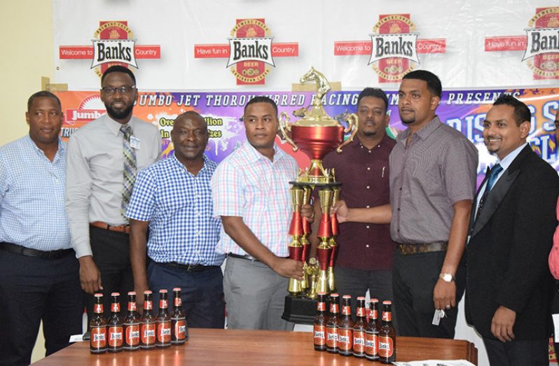 Banks Beer manager Brian Nedd (centre), poses with the Championship trophy with Nazrudeen Mohamed (second from right), in the presence  of Jones (2nd left) and Banks DIH managers and organisers of the event.