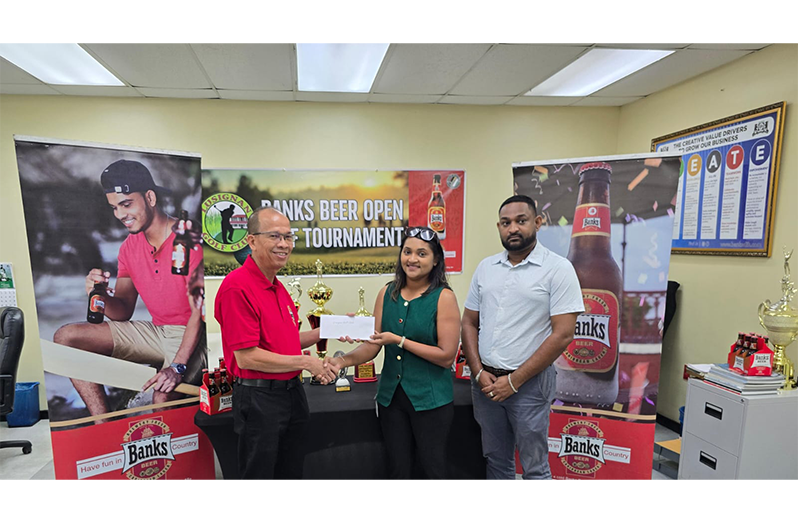 Brian ChooHen, Banks Beer Brand Manager hands over the sponsorship to LGC’s Joaan Deo. Basant Ramsarup, Banks Beer Brand Supervisor looks on