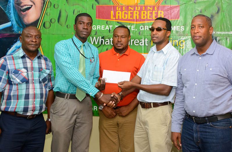 Banks DIH PRO Troy Peters watches as Petra’s Mark Alleyne collects a cheque from GT Beer brand manager Jeff Clement. Also in the picture are Petra Director Troy Mendonca and Banks Outdoor Events Manager Mortimer Stewart.