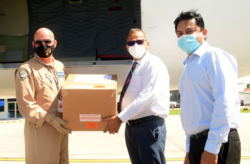 (Flashback, late Feb.) Minister of Health, Dr Frank Anthony (second right) and Chief Medical Officer, Dr Narine Singh, collect the vaccines, donated by Barbados to Guyana, at the Ogle Airport, on the East Coast of Demerara (Adrian Narine photo)