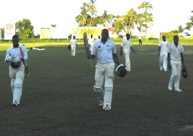 Well done skipper! As the shadows lengthen across the Everest Cricket Club ground yesterday afternoon, Randolph Knights (right) looks on as Christopher Barnwell acknowledges the applause of his teammates, following his unbeaten ton. At left is Kellon Carmichael.
