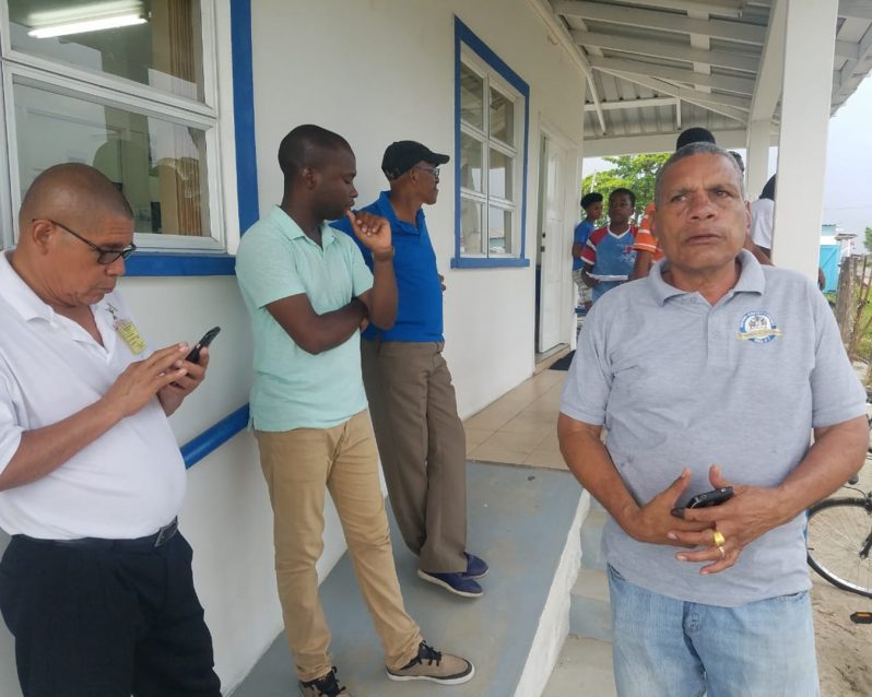Minister of Social Cohesion Dr. George Norton, Mayor of Bartica, Gilford Marshall and Regional Chairman. Gordon Bradford stand outside the GPL office in Bartica