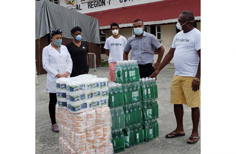 Medical personnel of the Bartica Regional Hospital receiving the sanitisers and other supplies from the Bartica COVID-19 relief team