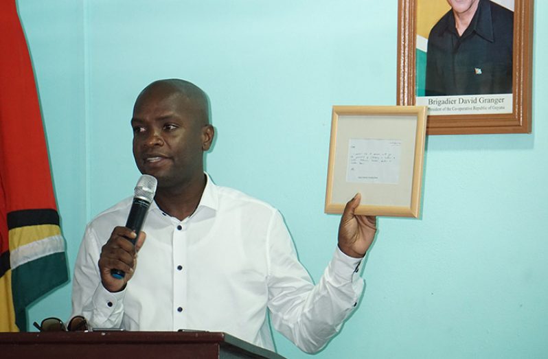 Mayor Marshall proudly displaying the framed note sent him by President Granger 