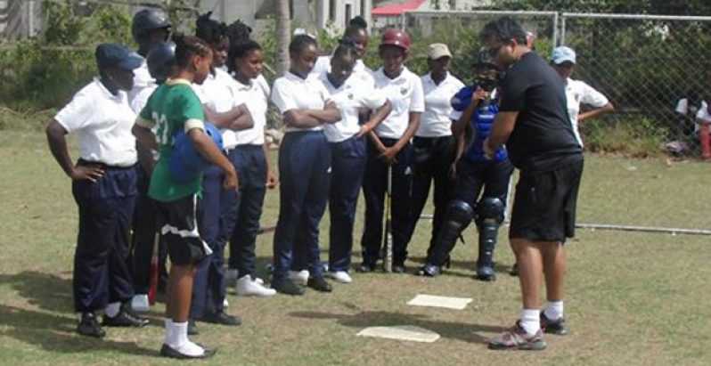 GBL president Robin Singh shows some new students the batting stance.