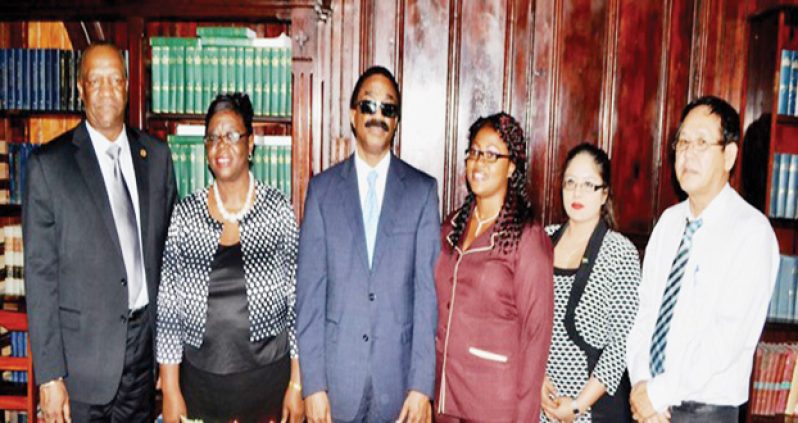 From left, Minister of State Joseph Harmon, Registrar of Lands Rosaline Robertson, Minister of Legal Affairs and Attorney General Basil Williams, Assistant Registrar of Lands Wendella Austin, Legal Adviser to the Ministry of the Presidency Geeta Chandan-Edmond and Chief Justice (acting) Ian Chang after the swearing-in ceremony at the High Court