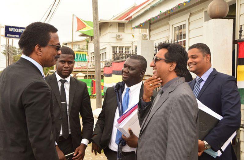 Attorney General Basil Williams and Attorney Anil Nandlall speaking outside of the Court of Appeal on Thursday in the company of other attorneys after the timelines were set