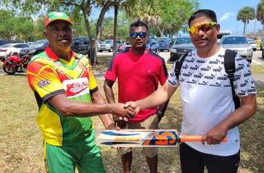 Rudolph Baker, left, collected the bat from Munna, on behalf of Mahadeo, in the presence of John Sumair