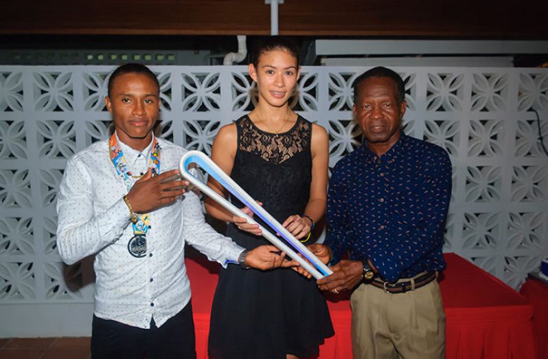 Champions! Commonwealth Youth Games 2017 silver medallist Keevin Allicock stands alongside Commonwealth Youth Games 2015 bronze medallist Taylor Fernandes who holds the Queen’s Baton 2018 Gold Coast. Guyana’s only Olympic medallist Michael Parris looks on.