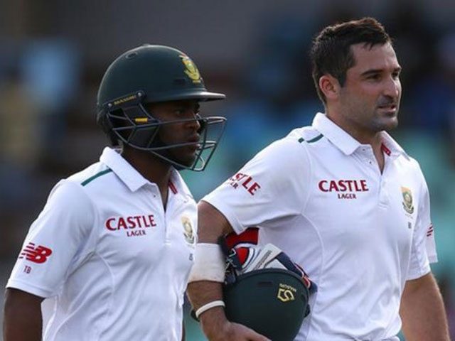 South Africa batsmen Temba Bavuma (left) and Dean Elgar walk off at the end of a day's play in a Test match.
