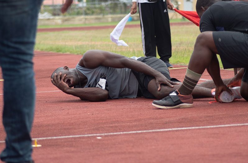 Leslain Beard is seen being assisted by Medics after sustaining a leg injury on  Sunday at the Leonora Track and Field Centre during the Javelin throw.