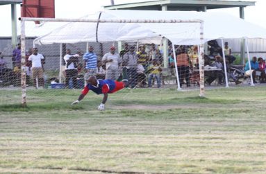 Beaten! Young Achievers custodian is caught by Chronicle photographer Sonell Nelson, being beaten by Martin Babb’s penalty in the 53rd minute.