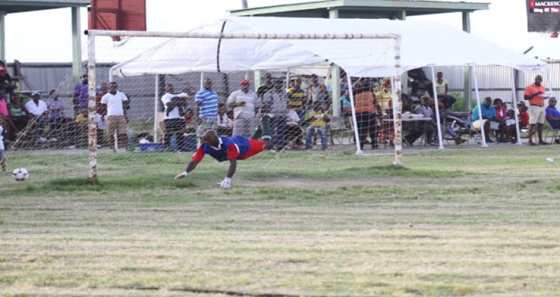 Beaten! Young Achievers custodian is caught by Chronicle photographer Sonell Nelson, being beaten by Martin Babb’s penalty in the 53rd minute.