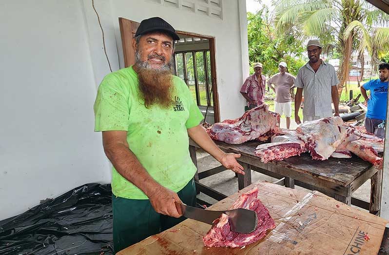 Imam of Meten-Meer-Zorg (East) Masjid, Halim Khan (in the background) overseeing the cutting up and distribution of beef