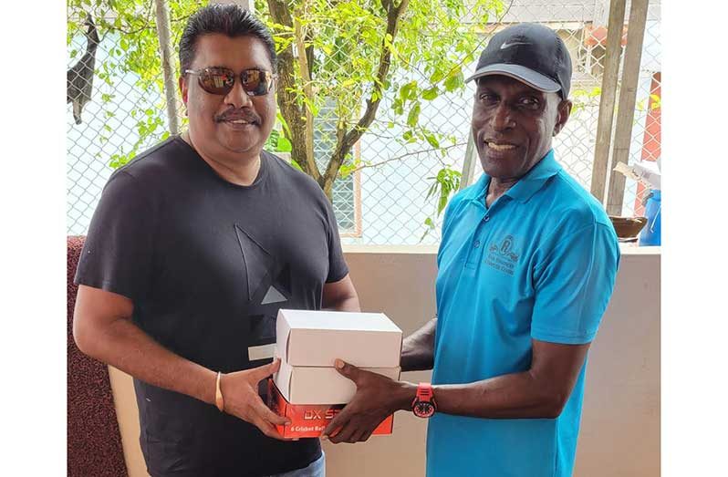 Anil Beharry, left, receives the balls from David Harper