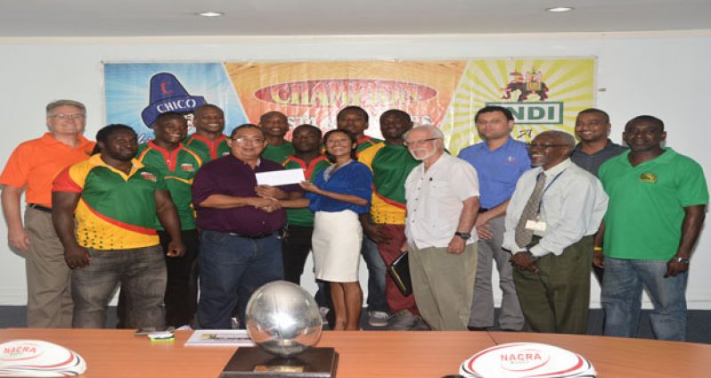 President of the GRFU is all smiles while he collects the US$10 000 cheque from Beharry Group of Companies Marketing Director Anjuli Beharry-Strand while other executives and players look on.