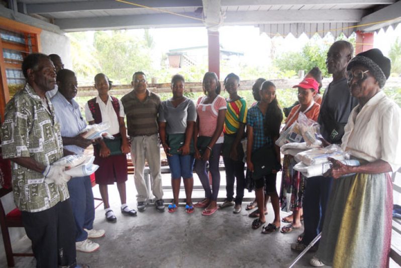 Some of the  CSEC 2014 students and the elderly with their respective kits, which was given as a result of  the intervention  of the Jesus Christ of Latter Day Saints Humanitarian  Mission