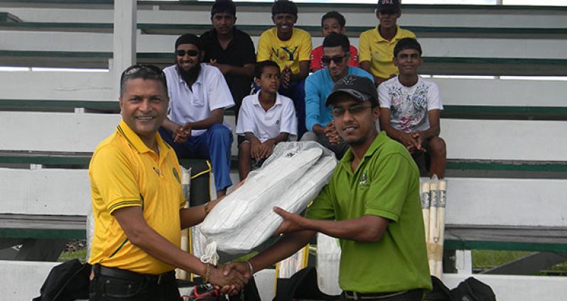 Safraz Ali, Industrial Welfare Officer and Committee Development Officer of Rose Hall Estate (right), receiving the kit from GCB Secretary, Anand Sanasie.