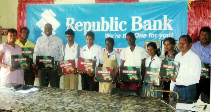 Representatives of five of the schools along with officials from the BCB and Republic Bank (Guyana) Limited pose while displaying a few of the scrabble boards which will be used during the tournament.