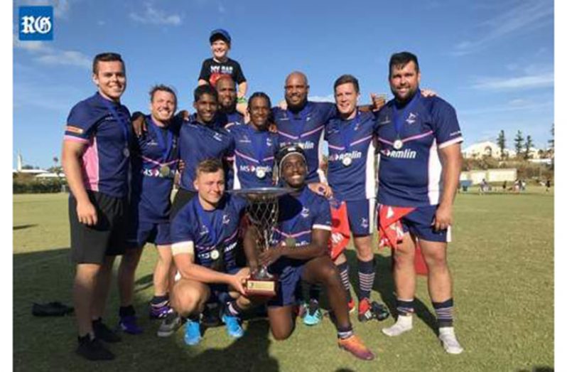 Some of the Bermuda men's squad pose with the trophy after being crowned Caribbean champions, beating Guadeloupe 33-10 in the Rugby Americas North Championship final at North Field, National Sports Centre (photograph by Akil Simmons). Photo extracted from the Royal Gazette.
