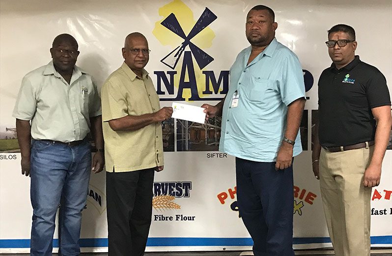 RHTYSC Secretary/CEO Hilbert Foster (second right) receives the sponsorship from NAMLICO Managing Director, Bert Sukhai, in the presence of other management officials.