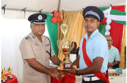 Deputy Commissioner of Police (Administration), Ravindradat Budhram, hands over the best-cop trophy to Sergeant 𝑫𝒊𝒗𝒆𝒏𝒅𝒓𝒂 Budraj of the Fort Wellington Police Station