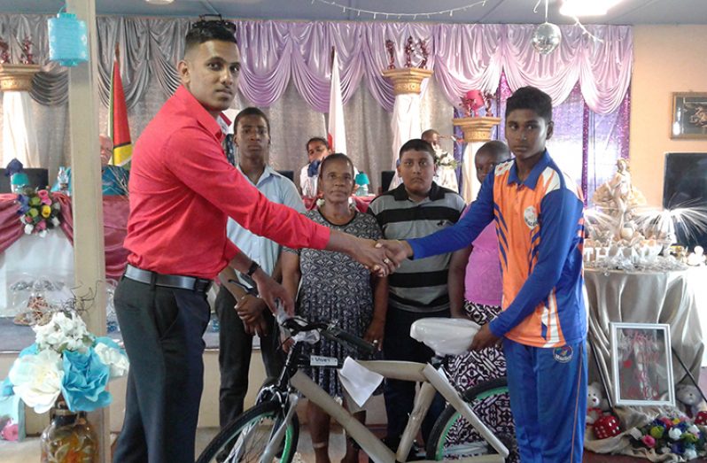 A representative from VNET Communication hands over one of the bicycles.