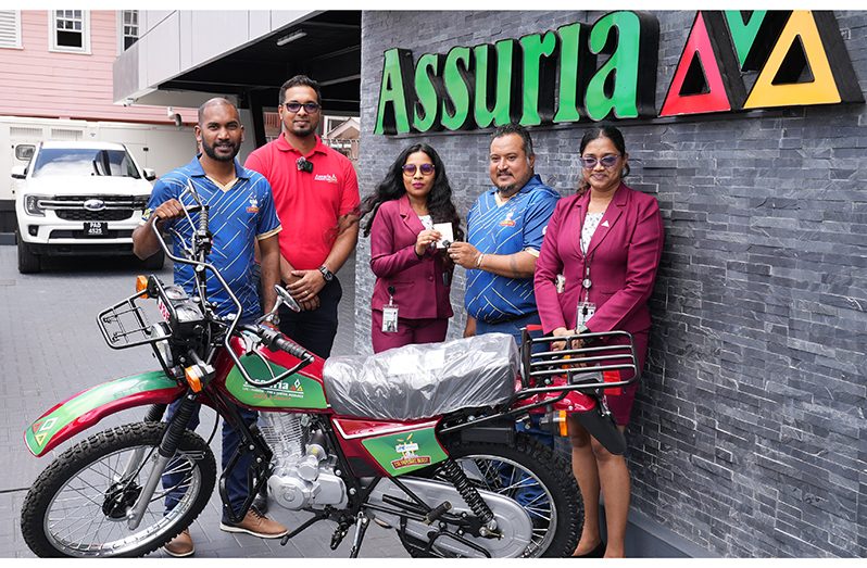 New Bike for MVP! From left: Co-Director of Kares One Guyana T10 Blast, Yusuf Ali; Sanjiv Nandlall, Assuria’s  Senior Supervisor for Information and Communications Technology (ICT) and Marketing; Fiona Sooklall (Fire and General Insurance); Co-Director of Kares One Guyana T10 Blast, John Ramsingh; and Nandanie Persaud (Marketing, Sales and Social Media Officer) at the company’s Church Street headquarters