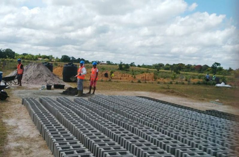 Workers laying the foundations for new dormitory facilities at the Bina Hill Institute, North Rupununi