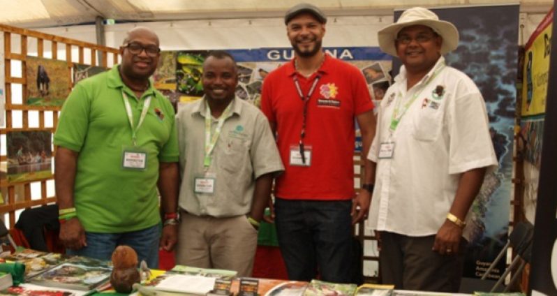 GTA Director Indranauth Haralsingh (right) and three others in the Guyana booth at the bird fair in England  