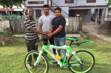 RHTY&SC Asst Secretary Simon Naidu and Mahendra Gopilall hand over the donation to David Black.