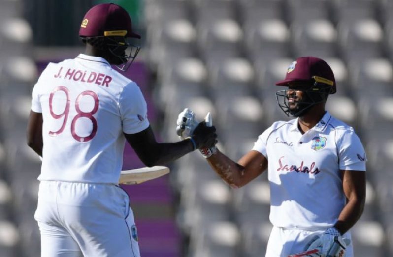 Captain Jason Holder greets Jermaine Blackwood in the middle during their small partnership on the final day of the opening Test.