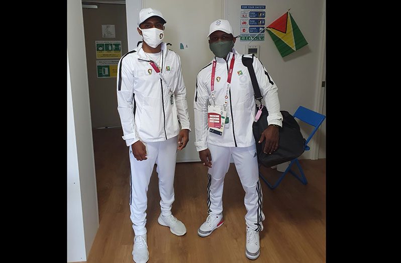 Keevin Allicock (L) and coach Sebert Blake prior to the Men’s Featherweight Division bout at the Tokyo Olympics.