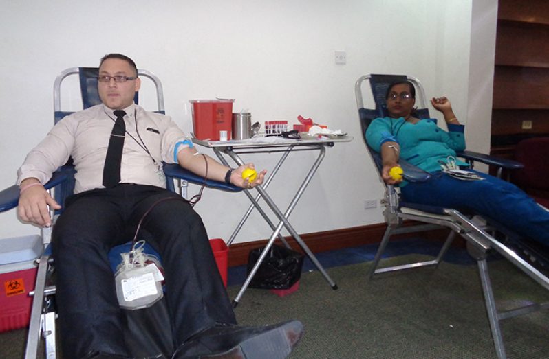 GBTI staffers, Christopher McIntosh and Maywati Khemlall making their contribution to the company’s annual blood drive on Wednesday