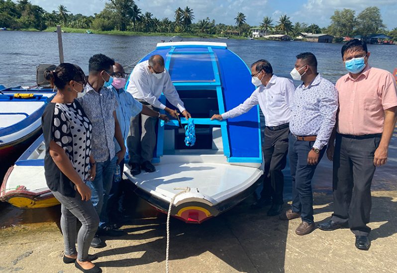 Minister of Health, Dr. Frank Anthony (fourth from left) cuts the ribbon officially commissioning the ‘Health Boat’